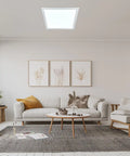 Modern living room with a white sofa, coffee table, decorative elements and square solar light.