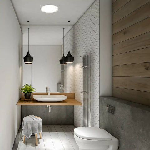 Modern bathroom with wooden vanity, white sink, toilet and solar light.