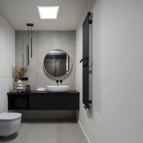 Modern bathroom with black vanity, round mirror, and solar light.