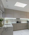 Modern kitchen with marble countertops, light gray cabinets and rectangle solar light.